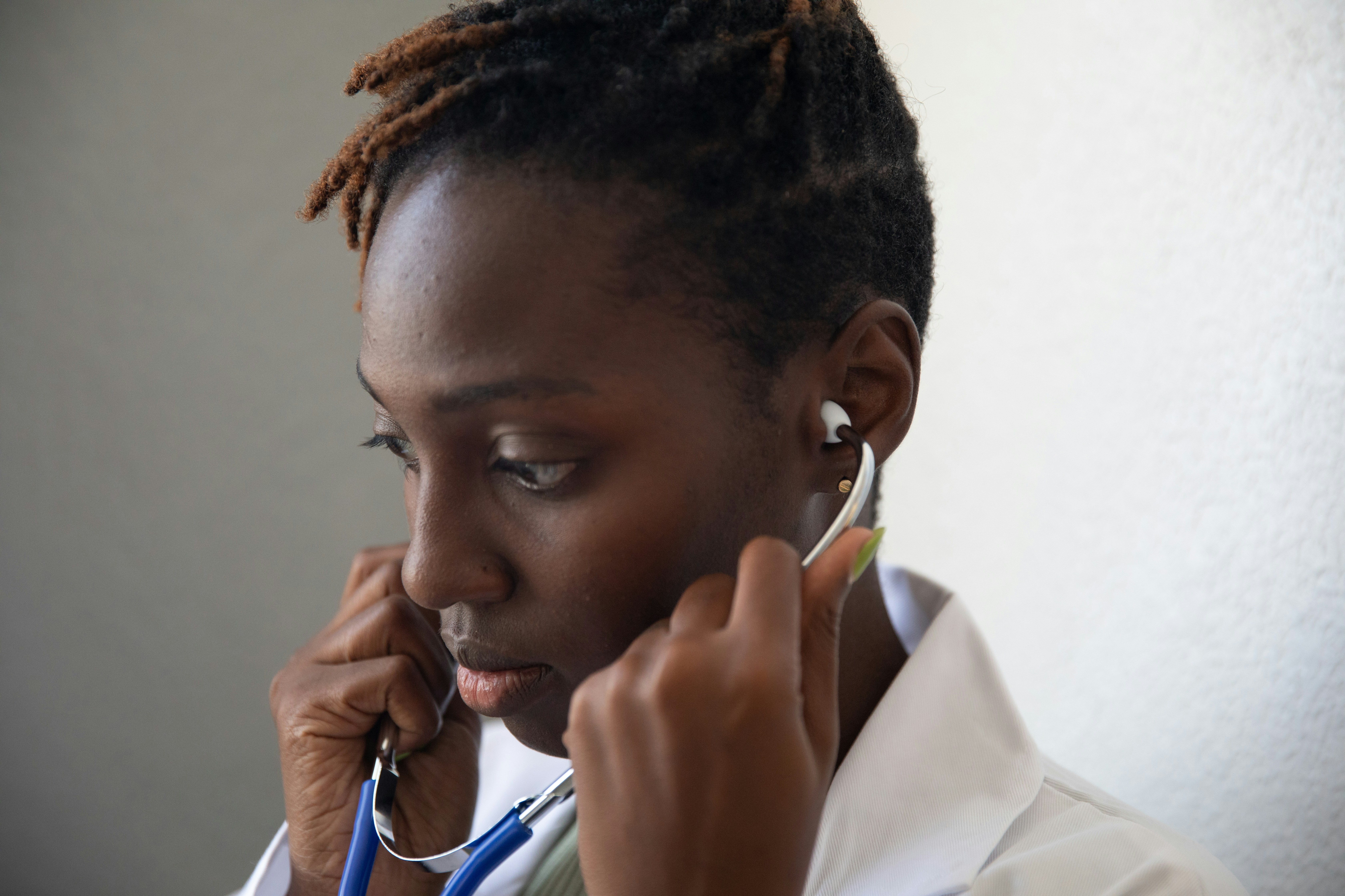 Healthcare professional putting on a stethoscope